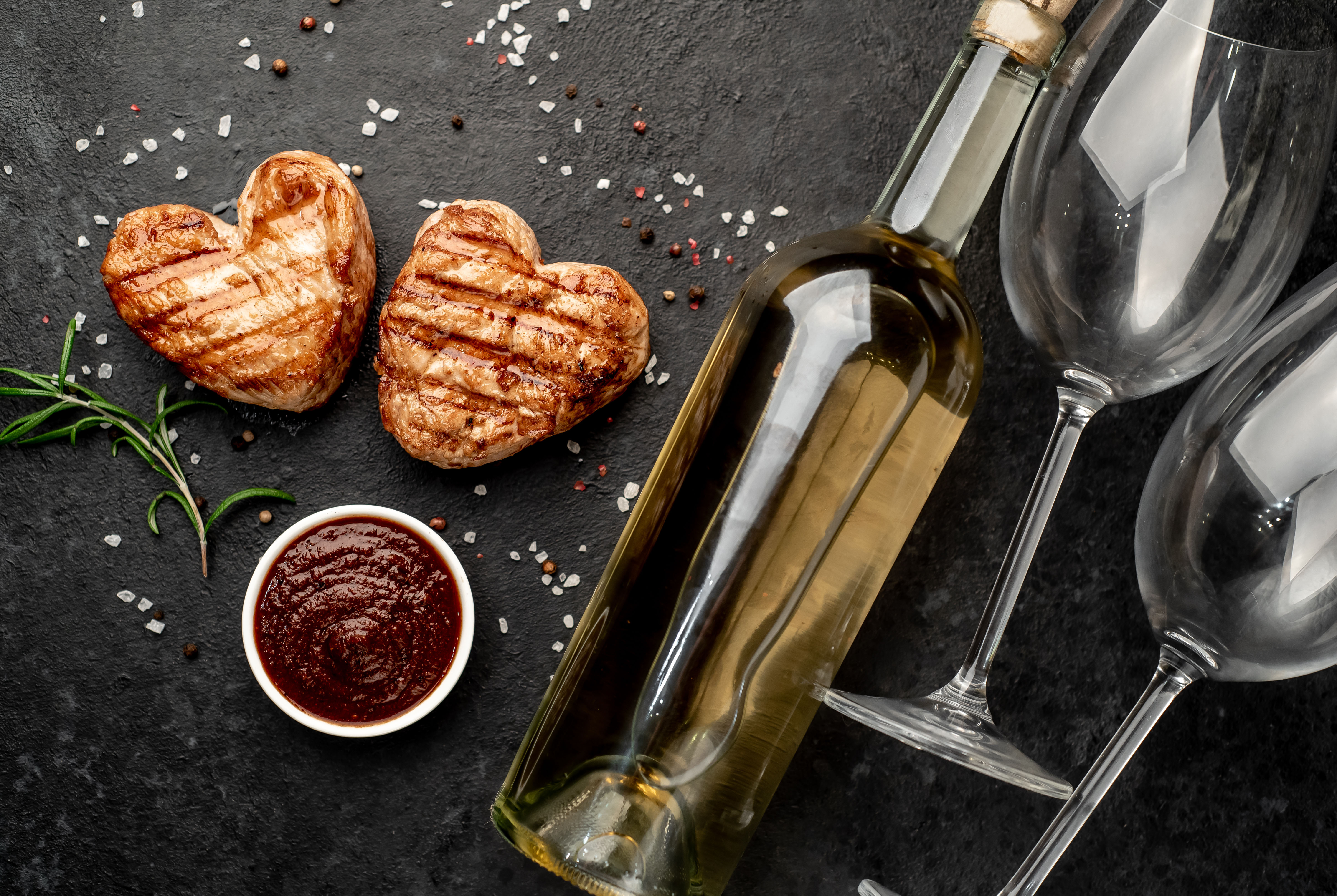 heart shaped pork chops with wine and glasses